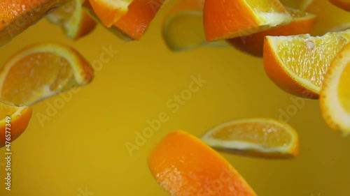 Wallpaper Mural Juicy delicious slices of ripe orange are bouncing up on the yellow background Torontodigital.ca