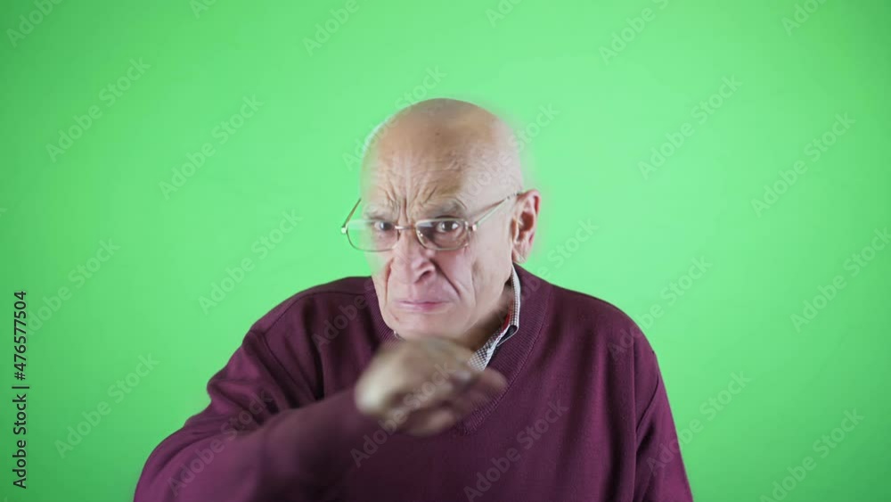 Scandalized senior man in glasses agitate with hand isolated on chroma key green background in studio. Human emotion concept. Scandalized senior man in glasses agitate with hand isolated on chroma key green background in studio. Human emotion concept.
