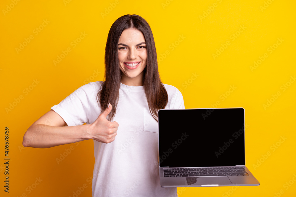 Photo of young pretty girl show thumb-up promoter ads promotion suggest isolated over yellow color background Photo of young pretty girl show thumb-up promoter ads promotion suggest isolated over yellow color background