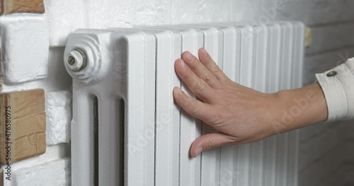 Wallpaper Mural Good central heating. A woman check her warm radiator in the room. Torontodigital.ca
