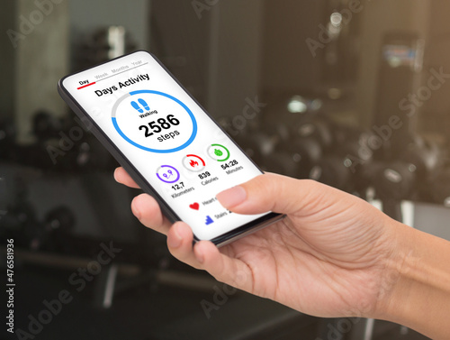 Wallpaper Mural Unrecognizable woman checking daily activity while exercising at gym Torontodigital.ca