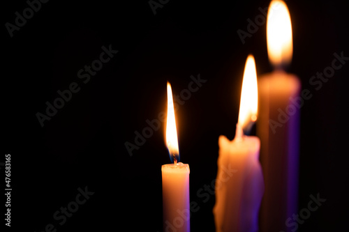 three candles on black