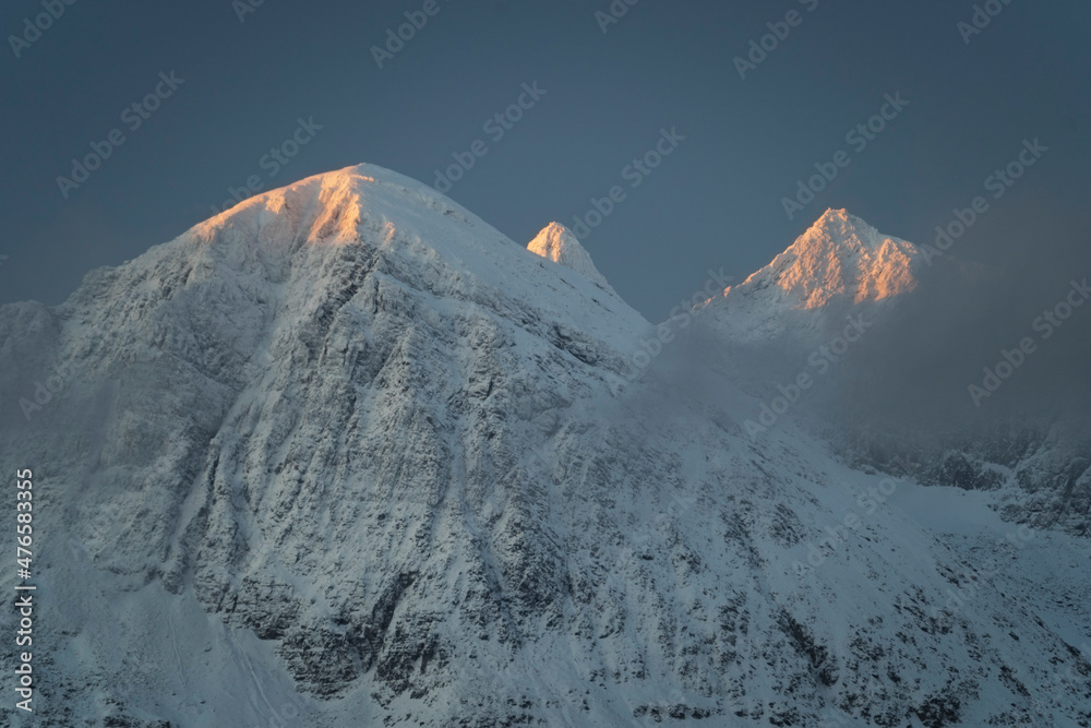 Snow covered mountains peaks at sunrise in arctic Norway