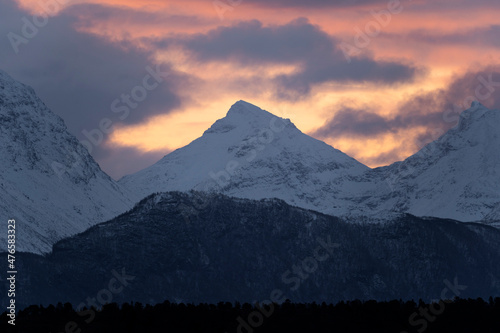 Amazing sunrise over snow covered mountains and fjords in northern Norway