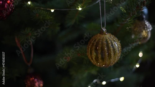 Chritmas decoratins on chritsmas tree with lights. Abstract background of Christmas balls. photo