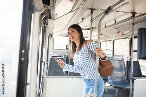 Woman Listening Music On Phone Riding In Bus