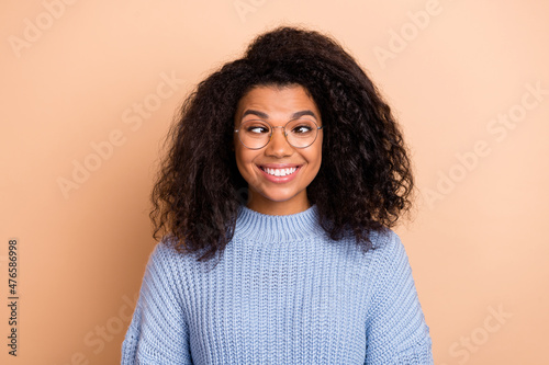 Photo of young cheerful woman have fun playful eyewear humorous isolated over beige color background photo