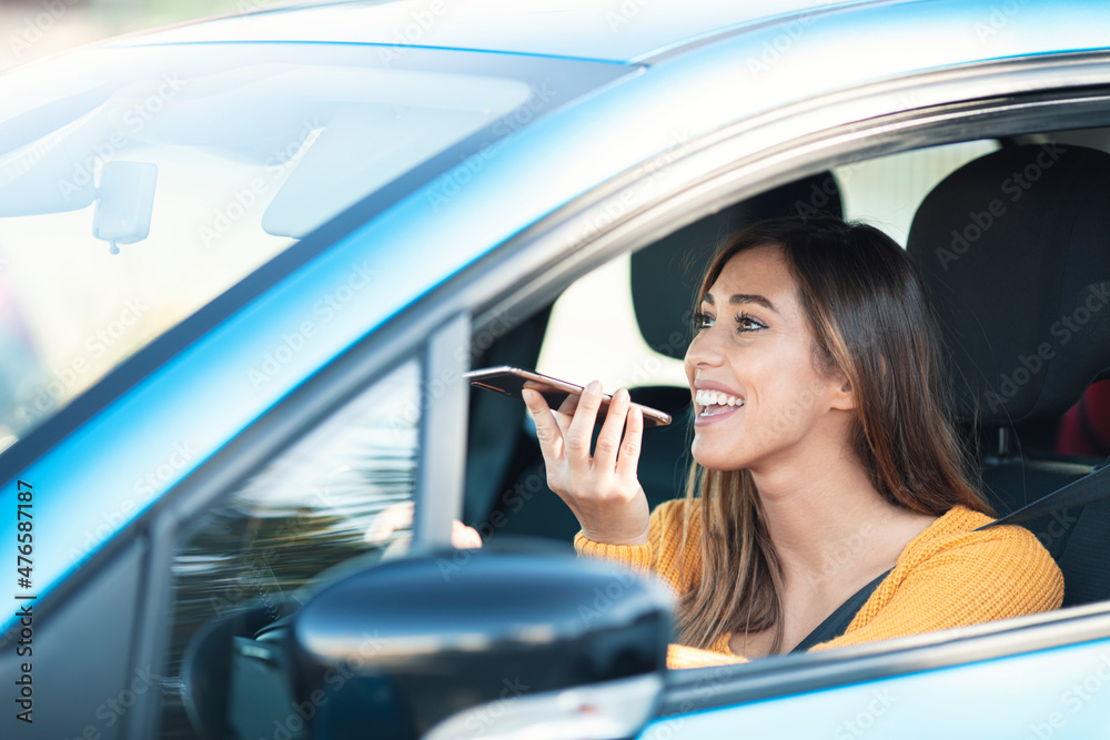 Brown hair happy Woman talking on the phone while driving a car. Brown hair happy Woman talking on the phone while driving a car.