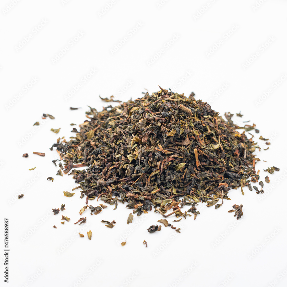 Black tea on a white background. Tea pouring. Whole leaf tea Black tea on a white background. Tea pouring. Whole leaf tea