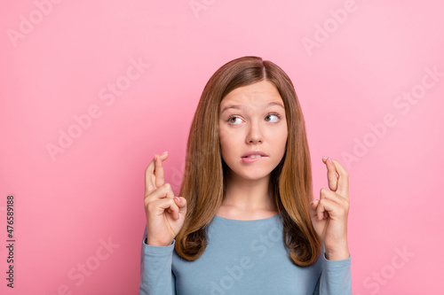 Photo of nervous blond teen girl look empty space wear blue shirt isolated on pink color background