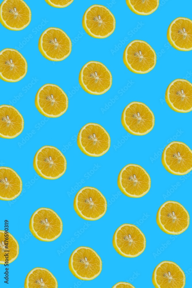 Lemon slices pattern, top view of lemon slices isolated on a blue background.
