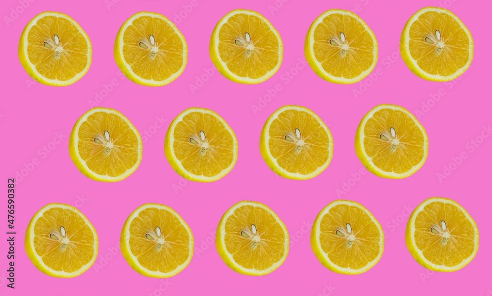 Lemon slices pattern, top view of lemon slices isolated on a pink background.