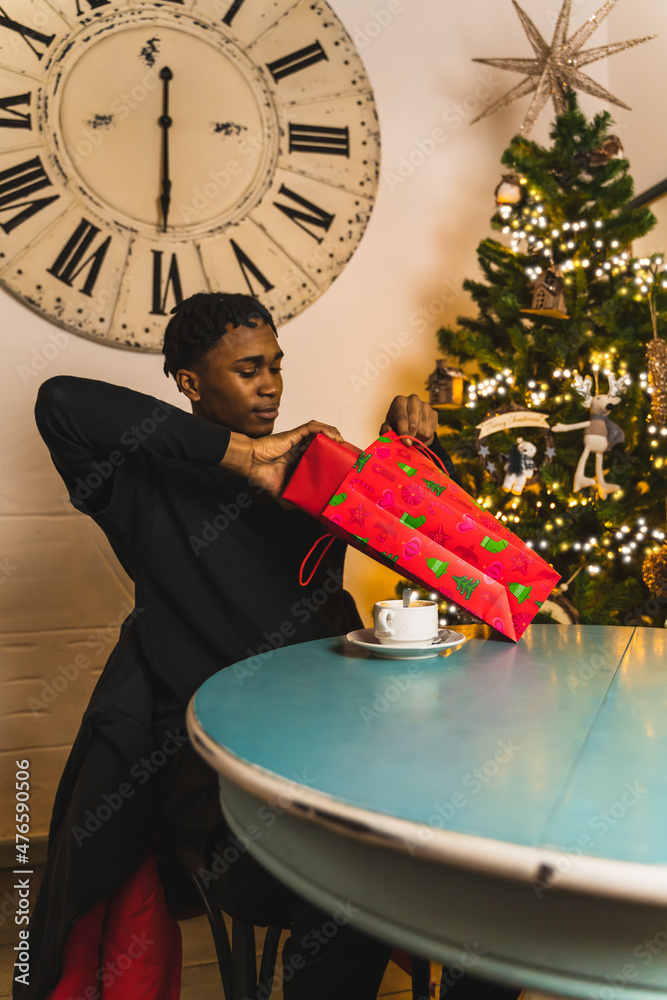 young boy pulling gift from bag