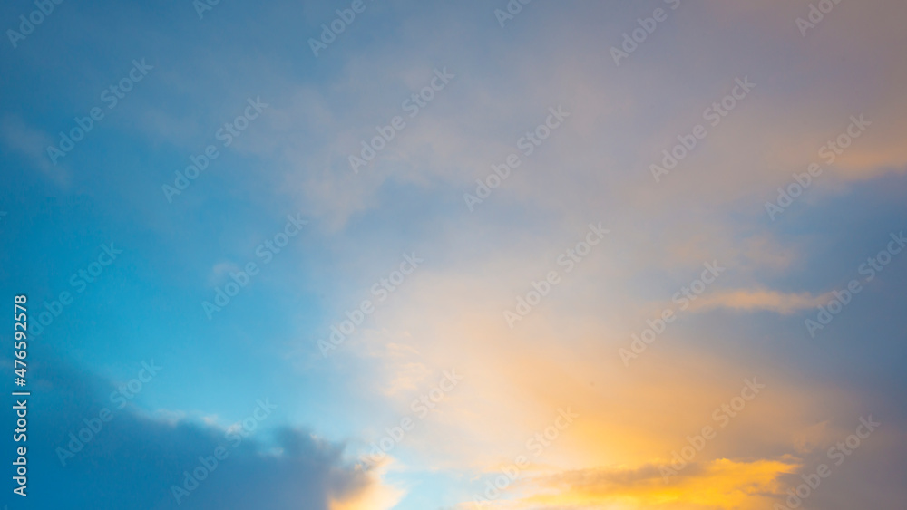 Clouds in a blue yellow sky in bright sunlight at sunrise in winter, Almere, Flevoland, The Netherlands, December 22, 2021