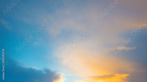 Clouds in a blue yellow sky in bright sunlight at sunrise in winter, Almere, Flevoland, The Netherlands, December 22, 2021