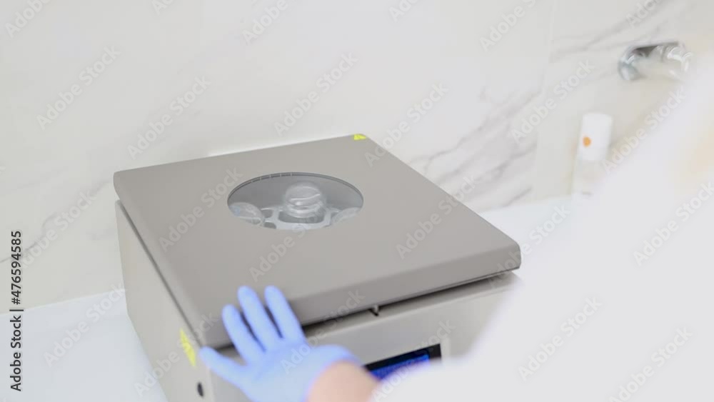 Doctor cosmetologist works with a centrifuge for plasmolifting Doctor cosmetologist works with a centrifuge for plasmolifting