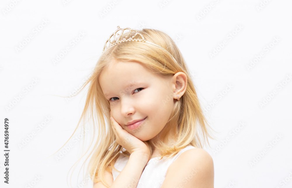 Funny little princess girl in silver crown and white dress over white background Funny little princess girl in silver crown and white dress over white background