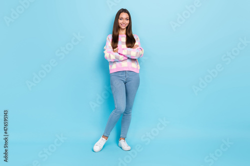 Photo of self-assured girlfriend crossed hands toothy smile wear sweater jeans footwear isolated blue color background