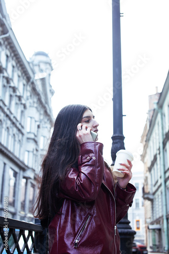 young pretty girl outside in city street with coffee happy smiling, lifestyle fashion peopple concept photo