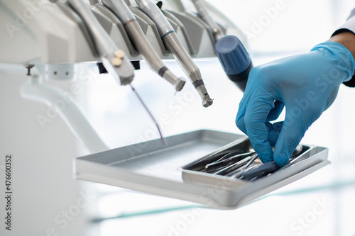 Closeup Shot Of Dentists Hand In Blue Glove Taking Sterile Stomatological Tools