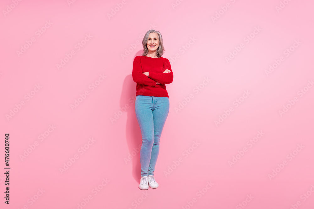 Full length body size view of attractive cheerful grey-haired woman folded arms posing isolated over pink pastel color background Full length body size view of attractive cheerful grey-haired woman folded arms posing isolated over pink pastel color background