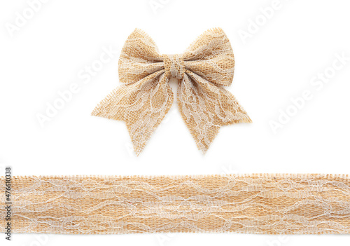 Pretty bow and ribbon made of burlap with lace on white background