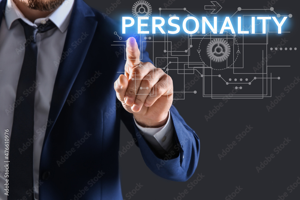 Man pointing at word PERSONALITY on virtual screen against dark background, closeup Man pointing at word PERSONALITY on virtual screen against dark background, closeup