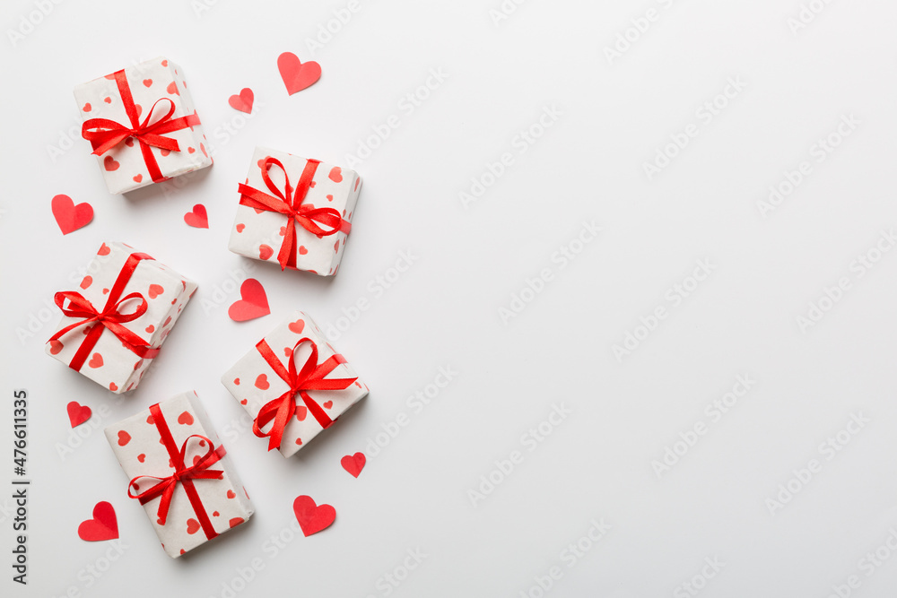 Valentine day composition: red gift box with bow and heart. Christmas present. View from above. Space for text. Holday greeting card Valentine day composition: red gift box with bow and heart. Christmas present. View from above. Space for text. Holday greeting card