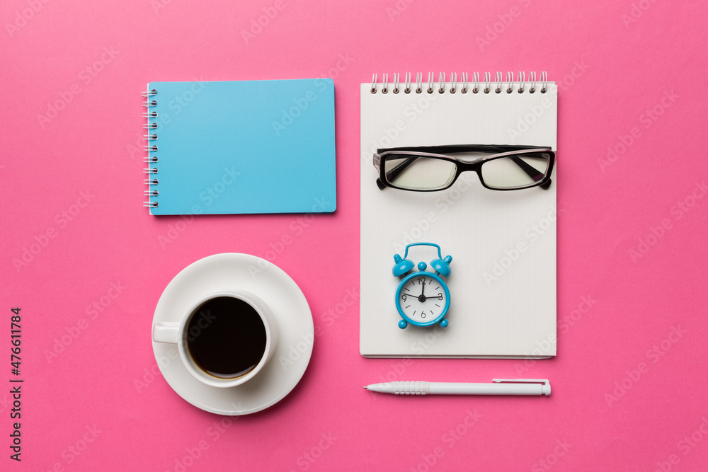 Modern office desk table with notebook and other supplies with cup of coffee. Blank notebook page for you design. Top view, flat lay Modern office desk table with notebook and other supplies with cup of coffee. Blank notebook page for you design. Top view, flat lay