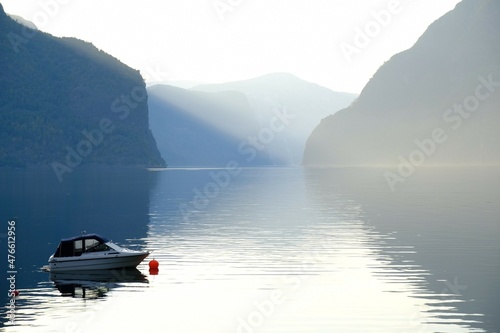 Amazing scenery of boat sanding on calm water of Aurlandsfjord in Norway in evening light. Aurlandsfjord is one of most beautiful fjords in Norway