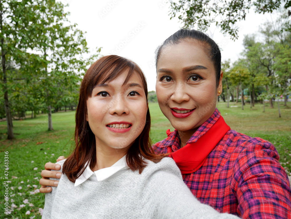 Beautiful young woman and mother smiling and selfie at park. Beautiful young woman and mother smiling and selfie at park.