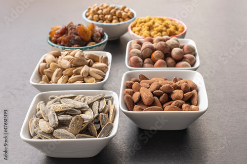 Sunflower in selective focus. Background of dried mulberry, hazelnut, pistachio, grape, almond, yellow chickpea and peanut in shell