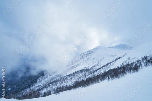 Image of a mountain covered with a snow cloud.