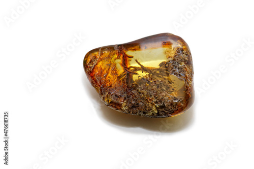 A piece of unique amber with inclusions on a white background. Inclusions in the form of chips, wood, fibers. Sun stone. Cured ancient petrified resin. Semi-precious natural mineral. Copal. Crystal. 