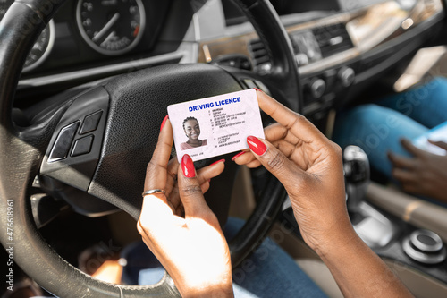 Fotobehang Closeup of driving license in black lady hands