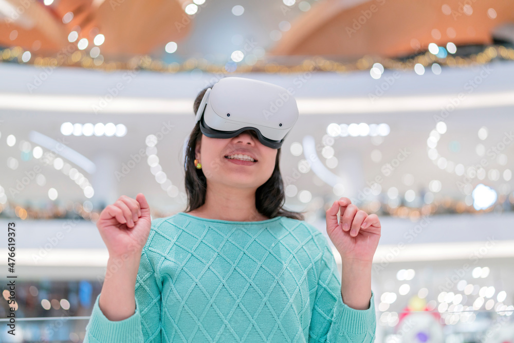 Exciting asian female wearing vr headset getting experience using VR-headset  glasses walking through metaverse of virtual department store mall ,asian  female enjoying VR goggles virtual shopping Photos | Adobe Stock