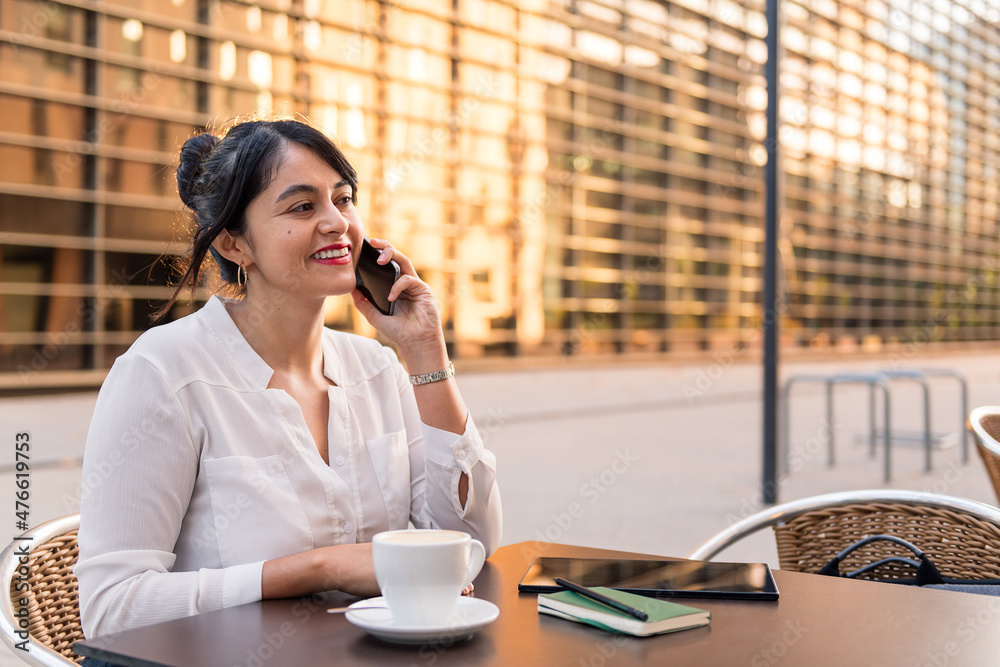 smiling businesswoman talking by phone