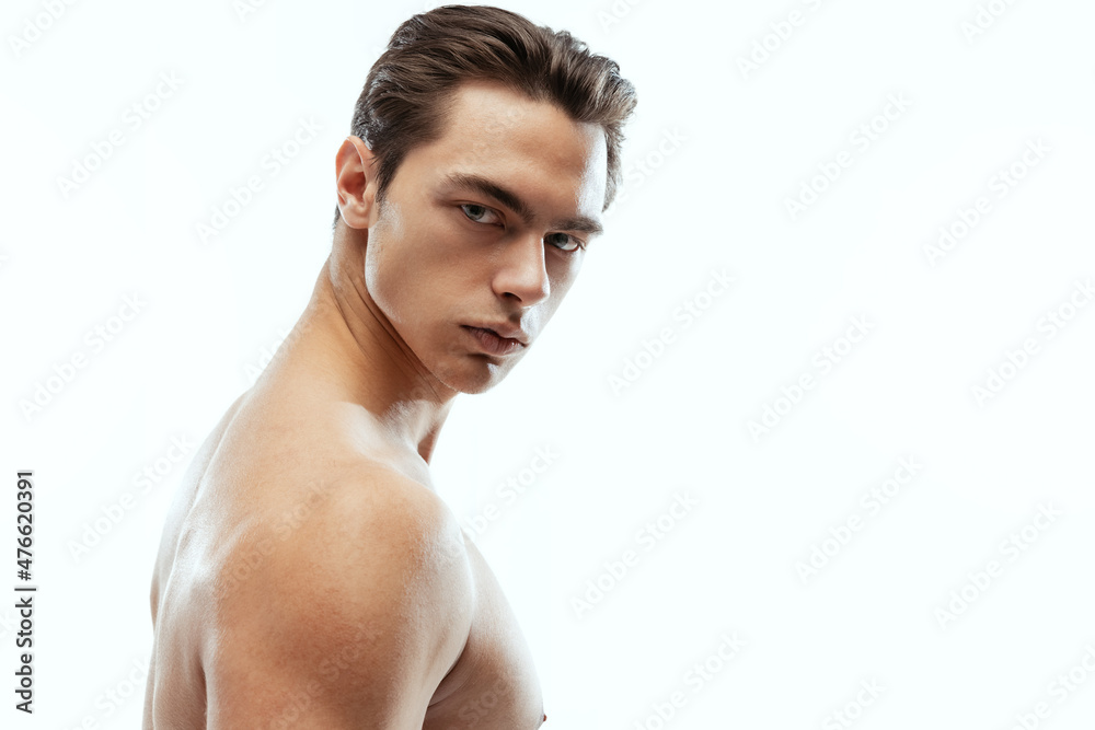 Close-up portrait of young handsome man isolated on white studio background. Concept of men's health and beauty