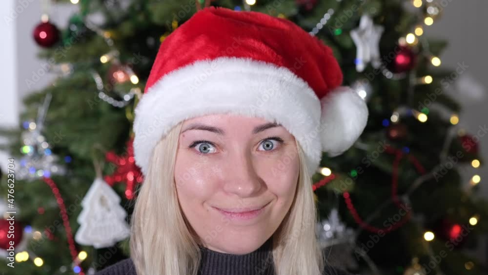 Girl in red Santa Hat shows emotions. Christmas and Hew Year concept. Portrait Girl in red Santa Hat shows emotions. Christmas and Hew Year concept. Portrait