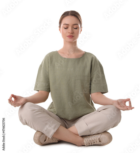 Beautiful young woman meditating on white background photo