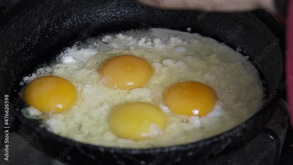 Cooking eggs in the pan. While there is cheese in the pan, cracking an egg on it.
Cooking eggs in the pan. While there is cheese in the pan, cracking an egg on it.