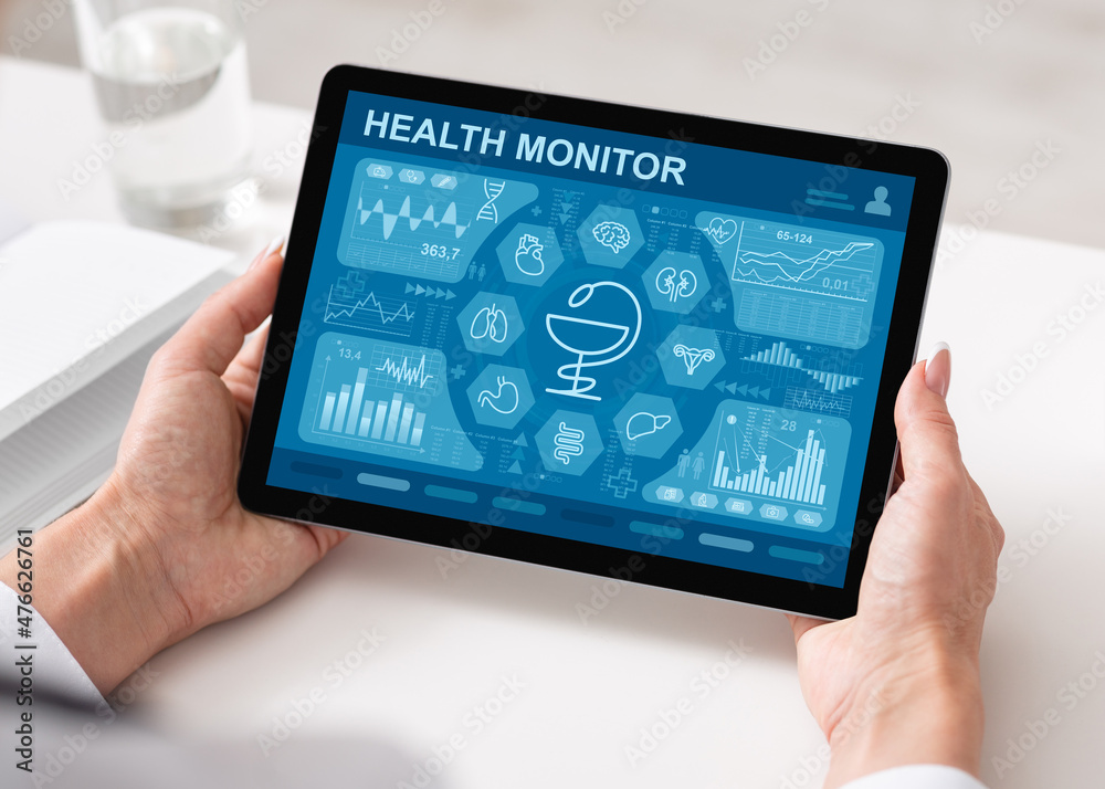 Cropped of woman using health application while working at office Cropped of woman using health application while working at office