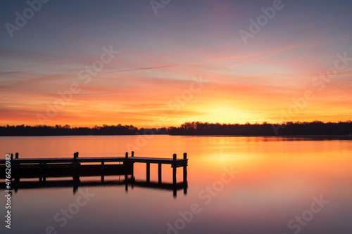 Cold and colorful dawn at a lake on a winters morning. © sanderstock
