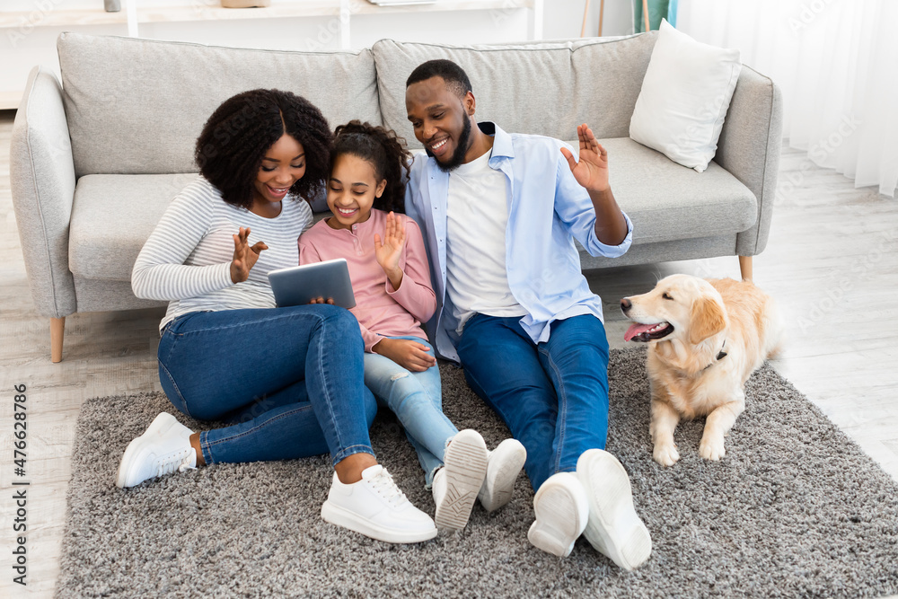 Black family having videocall using laptop waving hands Black family having videocall using laptop waving hands
