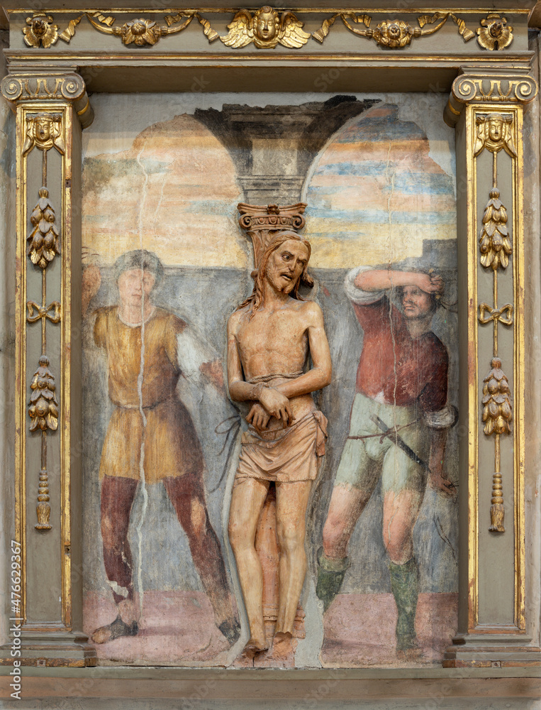 FERRARA, ITALY - NOVEMBER 9, 2021: The relief and of Flagellation (1450 - 1460) in church Chiesa di San Francesco with the fresco by Garofalo .
