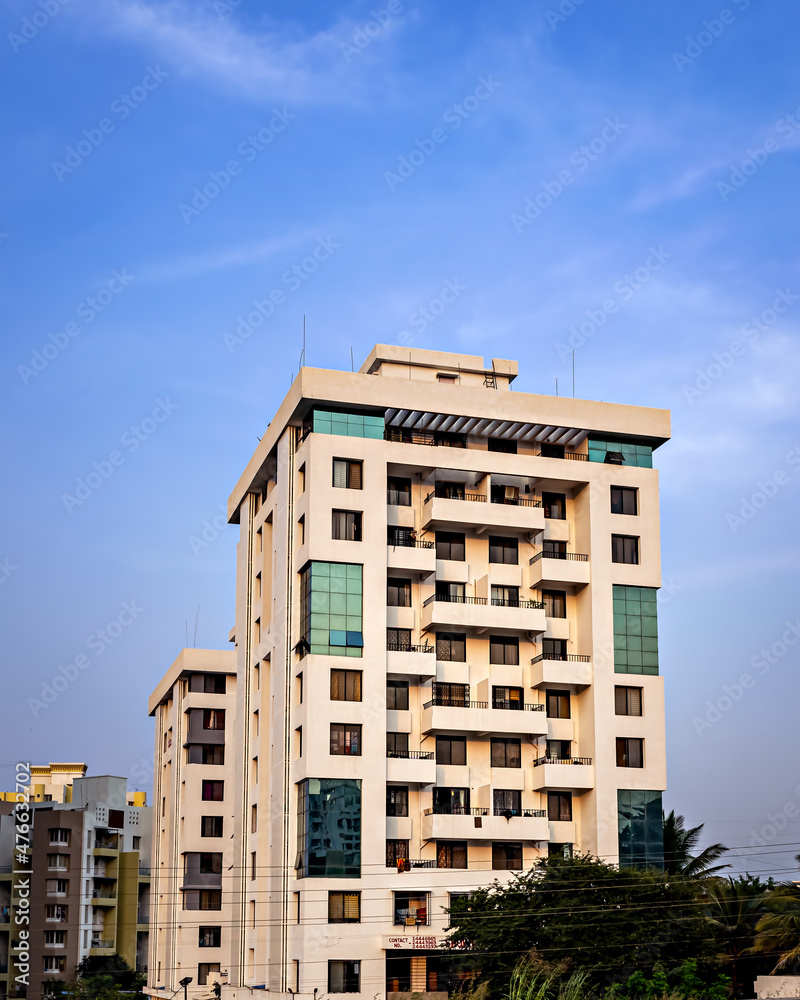 High rise, modern tall building with clear blue sky background.