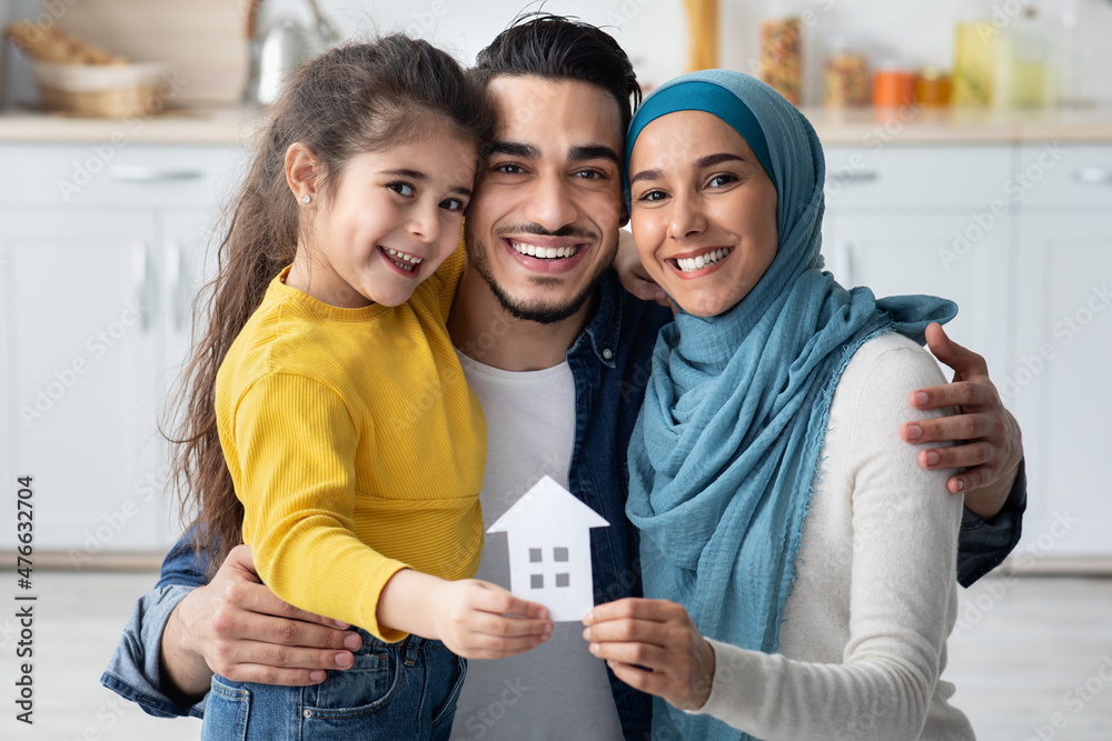 Family Housing. Happy Arabic Parents And Daughter Holding Ccutout Paper ...