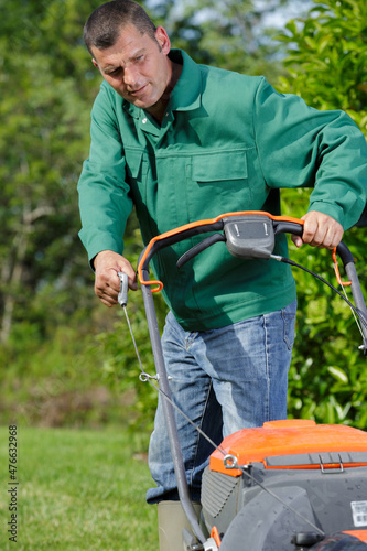 close up of mower cutting the grass photo