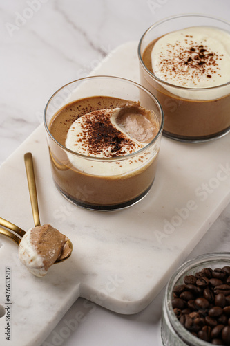 Italian chocolate and coffee mousse dessert semifreddo - half-frozen ice cream with whipped cream and cocoa powder in small glasses