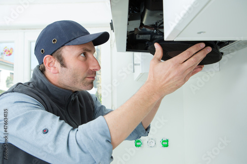 foreman fixing exhaust hood in the kitchen